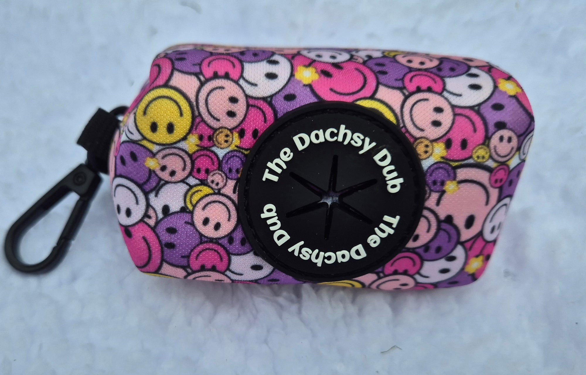 The one with the smiley faces poo bag
